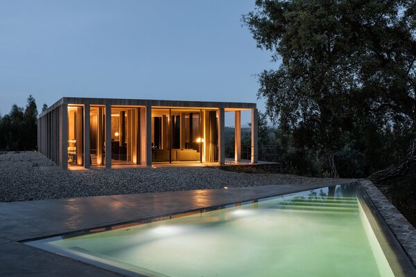 A triangular pool is also terraced into the landscape surrounding the pavilion-like house.