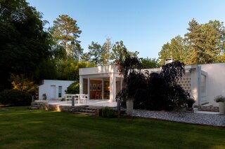 Another side of the home opens up onto a large lawn.