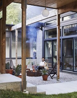 Bob sits in the entry courtyard with his dog, Goya.