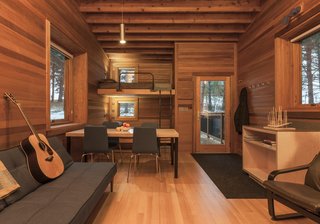 Built-in bunks are decked out with a private window for viewing the outdoors, and an adjustable reading light from Prima Lighting.  A simple pendant hangs above the main space.