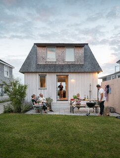 Friends and family hang out on the back patio. “It’s kind of a fugly house, but we don’t care,” Caleb says.