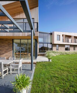 The larch slats above the brick reference a history of agriculture buildings in the area.